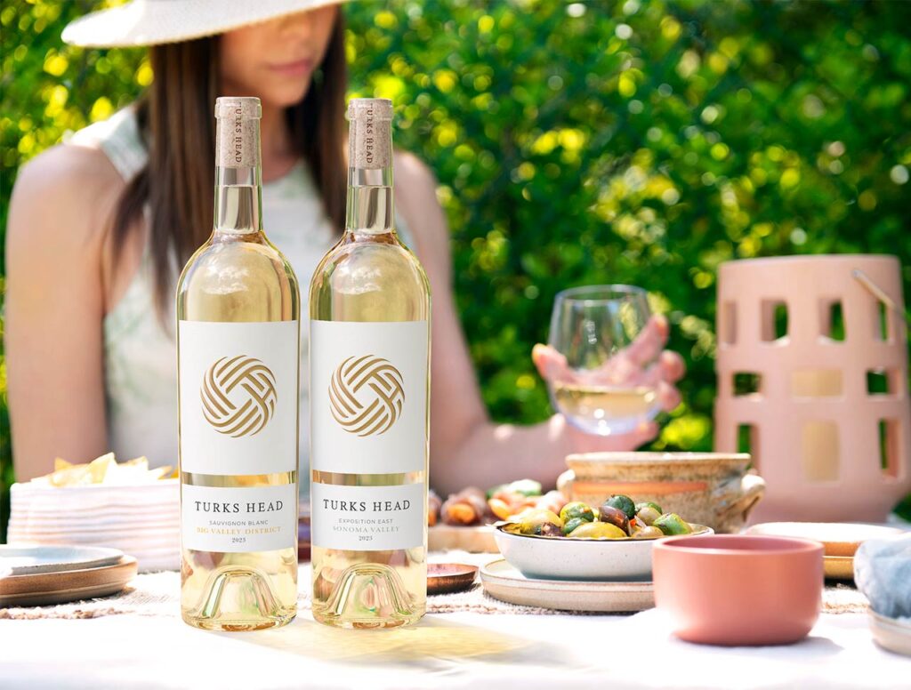 woman enjoying bottles of Sauvignon Blanc in the summer time